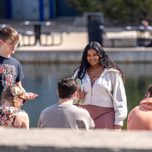 Sun, friends, and serenity - Ava Grillo, Gage Bergman, Ben Waunas, Samantha Rajenthiran, and Andrew Hurdy soak up the joy of a sunny day together by the picturesque Zumberge Pond on the Grand Valley State University campus in Allendale, Michigan on Mar...